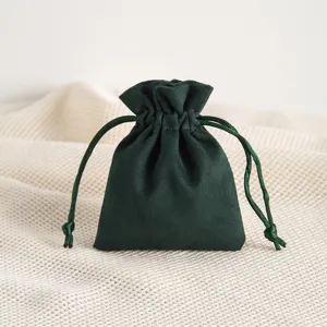 Close-up detail of dark green velvet drawstring gift pouch for jewelry and accessories storage.