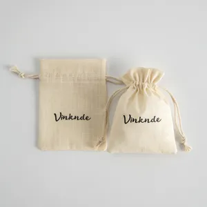 Beige slub cotton drawstring bags for jewelry packaging, linen small gift storage pouches.