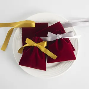 Rote Samt Schmuckbeutel mit goldenen und silbernen Schleifen, elegante kleine Geschenktüten.