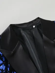 Men's sequin suit collar detail closeup, black peak lapel blazer texture display.