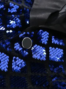 Close-up detail of men's sequin suit jacket featuring blue diamond sequins and satin lapel.