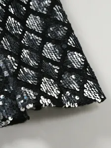 Men's sequin suit jacket sleeve detail close-up showing shiny diamond pattern for party.