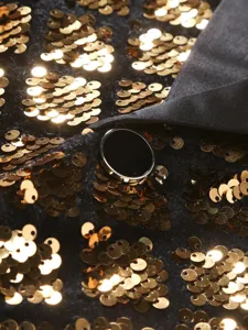 Gold sequin detail men suit jacket lapel button close up view fabric texture fashion apparel