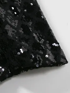 Close-up detail of black sequin fabric for men's formal suit lapel, premium shiny texture.