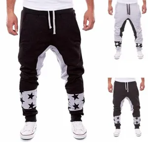 Men's colorblock drop-crotch sweatpants with adjustable drawstring and stylish star print cuffs.