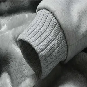 Close-up detail of grey thick fleece-lined men's hoodie cuff with soft interior plush.