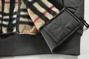Men's quilted jacket fleece lined detail view with classic check interior and warm fabric.