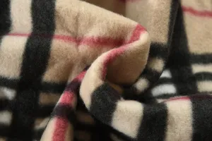 Close-up detail of mens winter warm fleece lined jacket fabric with classic plaid pattern.