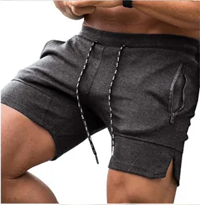 Detailed view of men's dark grey athletic gym shorts featuring convenient zipper pockets.
