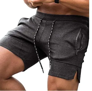 Men's casual athletic shorts detail featuring adjustable drawstring and practical zippered pockets.
