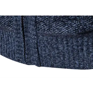 Detailed view of men's blue knit cardigan zipper and ribbed hem texture closeup.