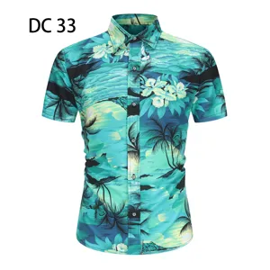 Close-up tropical palm tree print short sleeve shirt turquoise resort fashion detail.