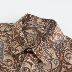 Detailed view of men's short sleeve shirt collar featuring classic brown paisley pattern.