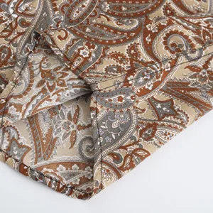 Detail view of men's casual paisley print short sleeve shirt hem, stylish summer fashion top.