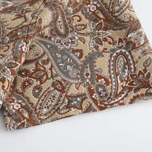 Close-up fabric detail of men's short sleeve shirt with classic paisley print design.