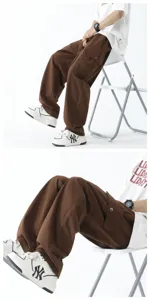 Close-up details of brown loose cargo pants, showing baggy straight leg fit and pocket design.