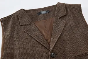 Close-up detail of men's brown herringbone suit vest collar, lapel design and lining.