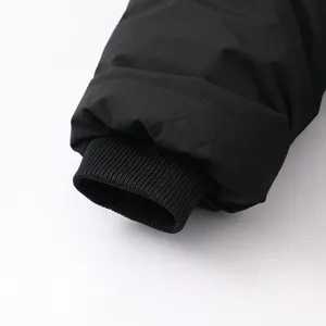 Black winter parka coat sleeve detail, windproof ribbed cuff design, warm outerwear.
