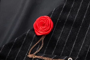 Close-up view of men vintage pinstripe vest fabric with red rose brooch and golden chain.