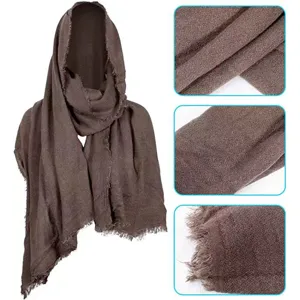 Medieval hooded cloak fabric detail showing brown textured fabric and frayed fringe.