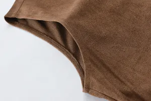 Close up of men brown suede vest detail, showing fine fabric texture and neat stitching.