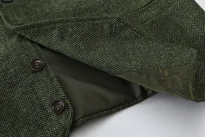 Detailed view of green herringbone tweed suit vest showing high-quality fabric and buttons.