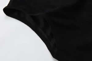 Black sleeveless vest detail shot, casual men outerwear close up view showing fabric texture.