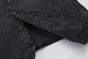 Close-up detail of men's vintage herringbone suit vest, showcasing fabric texture and buttons.