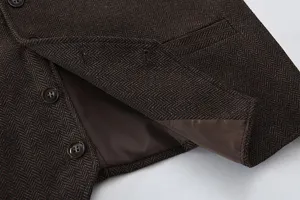 Men's brown herringbone tweed vest detail shot, business casual waistcoat fabric showcase.