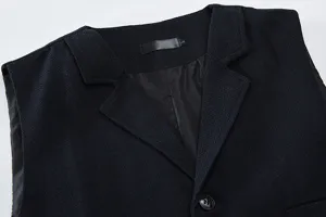 Detailed view of dark blue herringbone suit vest collar, showcasing textured fabric and lapel.