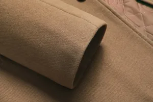 Detail of men's thickened wool trench coat sleeve with quilted lining, warm winter outwear.