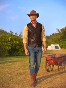 Vista di dettaglio outdoor che mostra un gilet in pelle marrone da uomo con scollo a V.