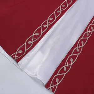Medieval renaissance dress detail showing red fabric with elegant white embroidery pattern.