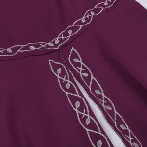 Close up detail view of medieval vintage renaissance dress with elegant silver embroidery.