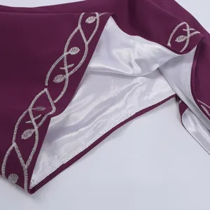Detailed view of medieval retro dress with silver embroidery and white lining for renaissance style.