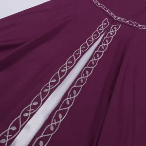 Medieval vintage dress embroidery detail shot showcasing intricate silver floral patterns on purple fabric.