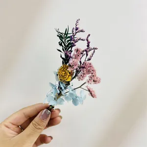 Dettaglio mini bouquet fiori secchi, materiale floreale artigianale per decorazione cornice DIY.