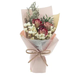 Mini dried flower bouquet with preserved roses and baby's breath, perfect gift for girls.