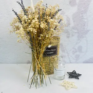 Detailed close-up of dry flower bouquet with lavender and gypsophila in woven pot setup.