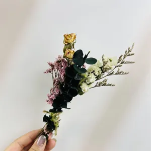 Mini dried flower bouquet detail, natural eucalyptus and small dried roses for gift box decor.