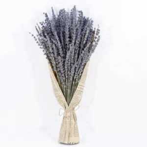 Dried lavender bouquet with vintage newspaper wrapping paper, perfect for home decor and gifts.