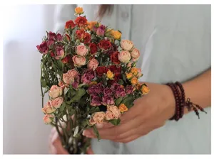 Dried multi-headed rose flower bouquet detail view, vintage dry real flowers for home decor.