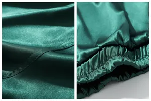 Dark green satin boxer shorts fabric detail, smooth silky lounge pants elastic waistband.