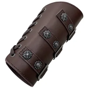 Close-up detail of the vintage medieval leather bracer with metal floral conchos and buckle.