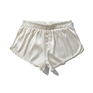 Detail view of men's silk satin boxer shorts in champagne, comfortable loungewear sleep bottoms.