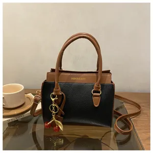 Classic color-block handbag with cute cherry charm, elegant shoulder bag for daily style.