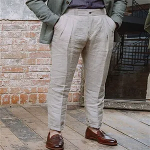 Detailed view of men's casual linen trousers, showing pleats and breathable texture.