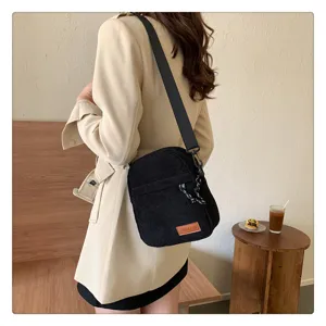 Stylish black corduroy crossbody bag for women, casual daily shoulder handbag with wide strap.