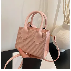Pink PU leather mini handbag detail, trendy woven texture crossbody tote bag for women.