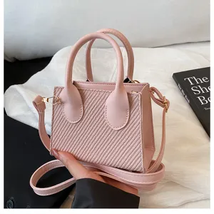 Pink mini structured tote bag with top handles and detachable strap for women fashion style